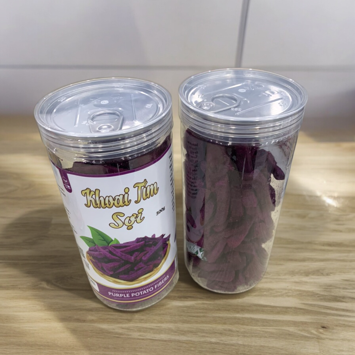 24447_z5494823921859-45144835de149fe9819502ee69c6f75f-photoroom_20240601141727-1.png Khoai Lang Tím Sợi Cộng Giòn 300g - 8936208930912